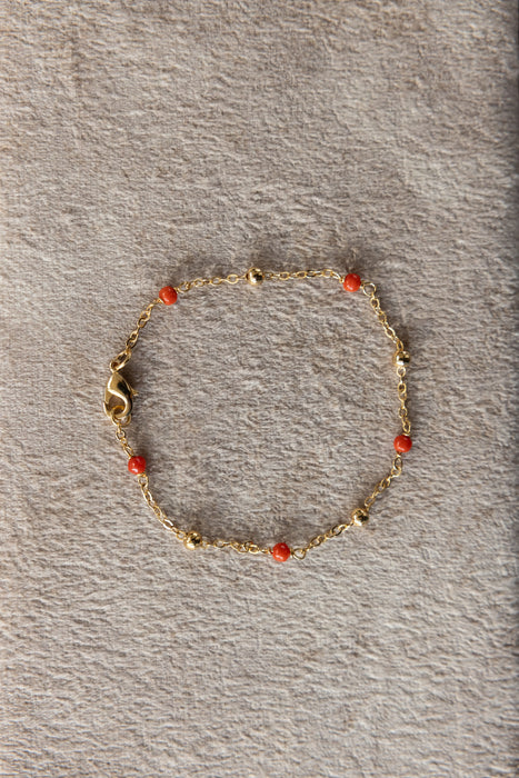 Bracelet de 20 cm plaqué or 24 carats avec boules de diamètre 3 mm plaquées or et perles de corail de diamètre 3 mm.